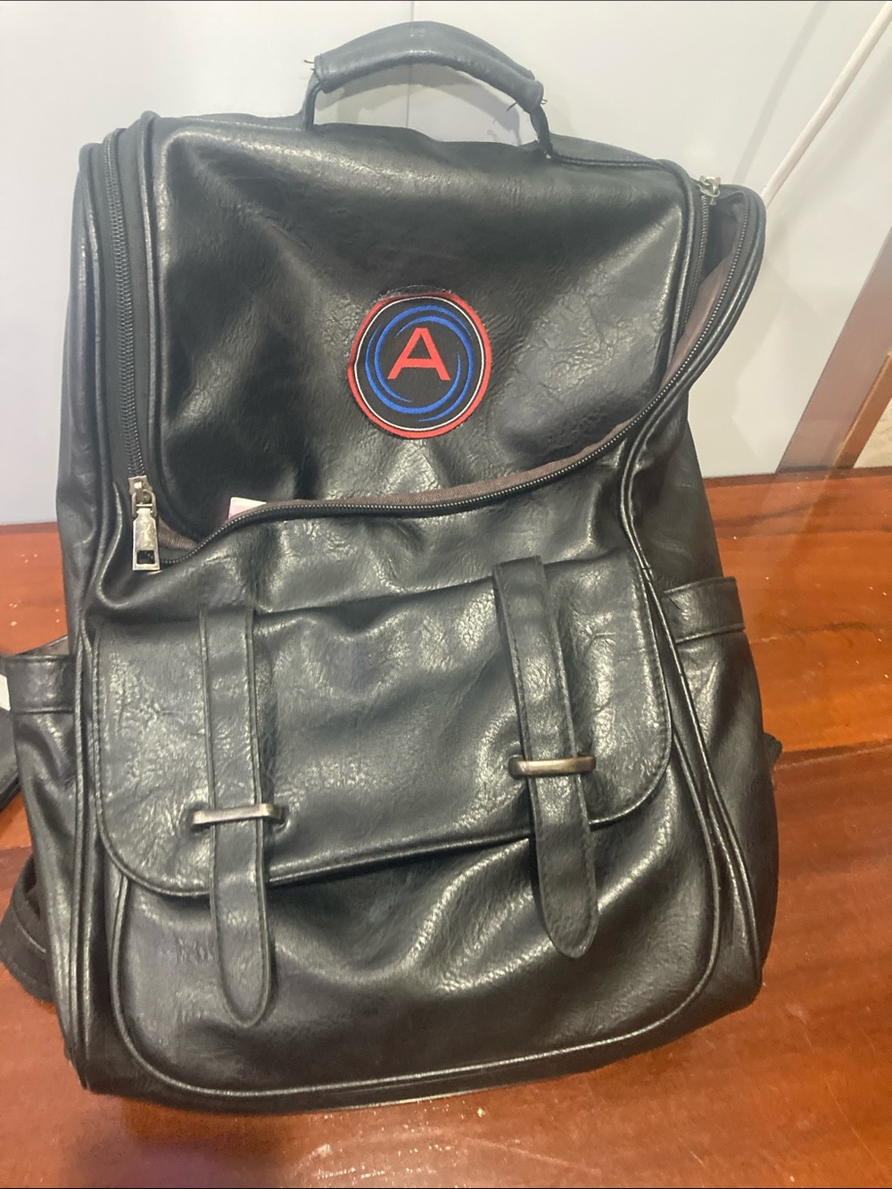 Black Leather-Look Men's Backpack with Red & Blue Patch